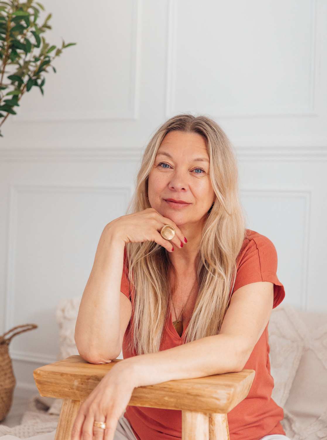 Ruth Mitchell Clear Energy Therapy practitioner and money blocks coach seated at her Poundbury Dorset practice